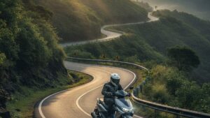 Electric scooter riding up a winding ghat road in India with green hills