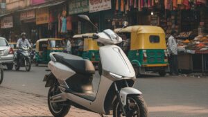 A modern lightweight electric scooter parked on a busy Indian city street, showing a practical urban commuter