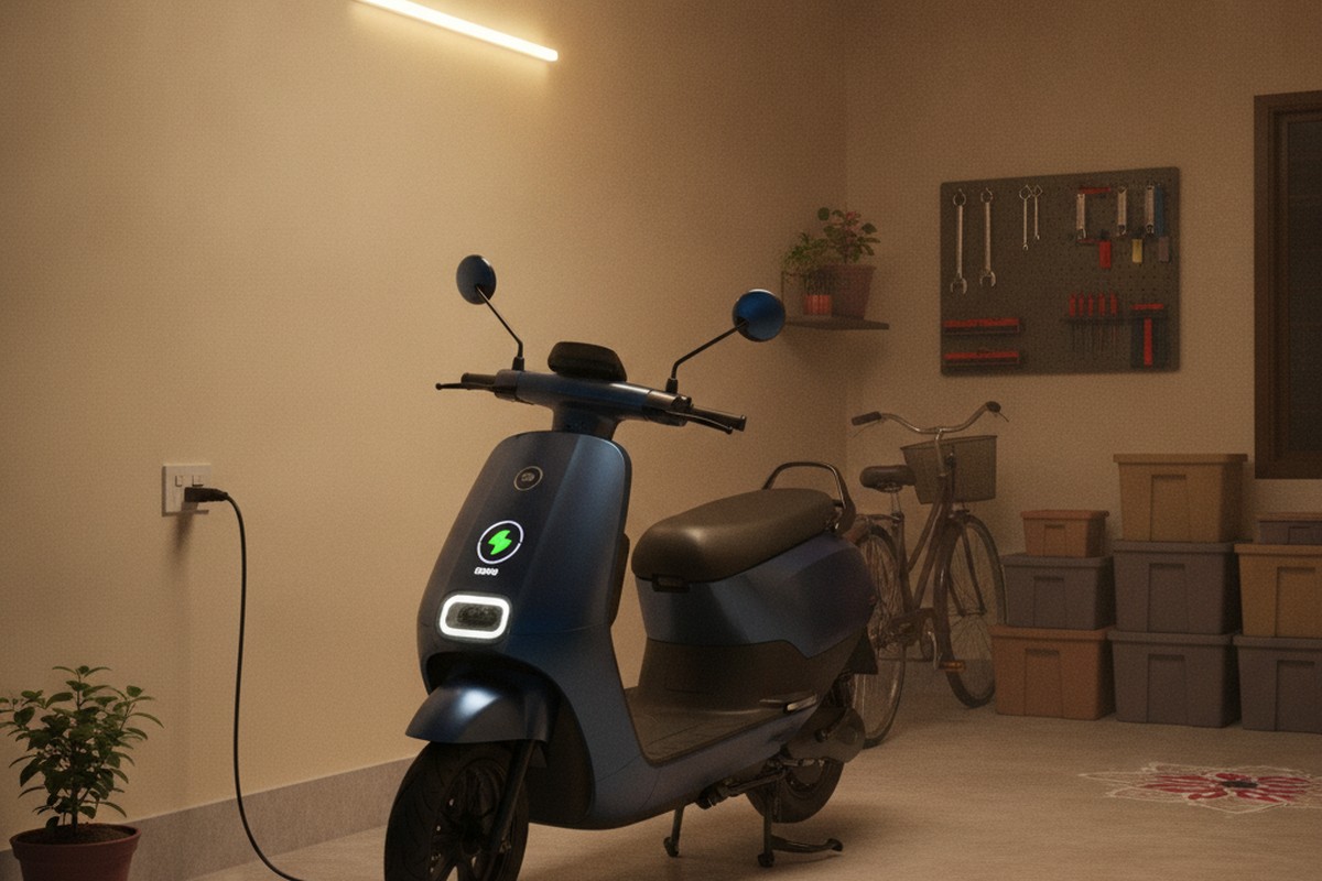 Electric scooter charging at home in an Indian household garage at night, showing the convenience of home charging