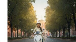 Young Indian college student riding an Elektree electric scooter on a city road