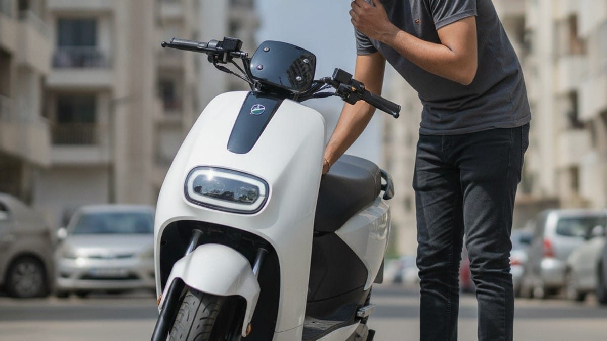 Indian buyer examining electric scooter to understand resale value before purchase